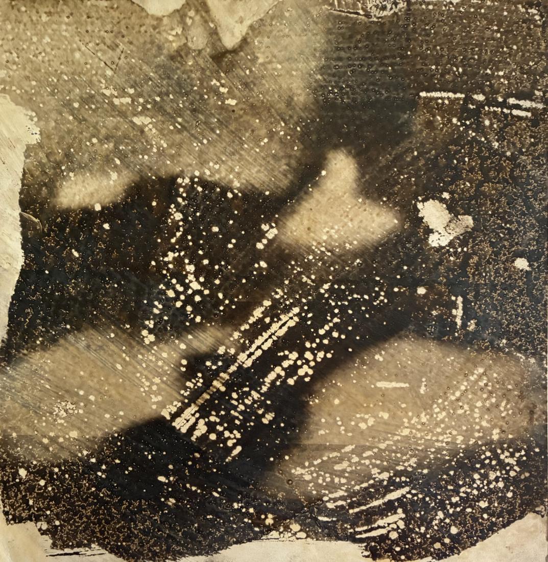Test strip: black cloud-like forms scattered with white specks over a pale sepia ground
